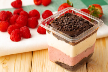 Mousse dessert with chocolate on wooden background