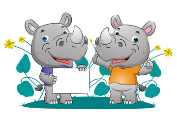 The couple of smart rhino explaining something while holding the blank banner