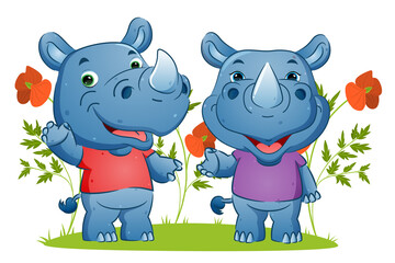 The couple of happy rhino waving the hand and giving the happy smile in the garden