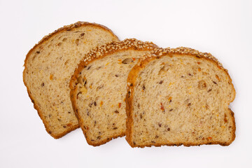 Three slices of whole-grain bread with vegetables, flax seeds and sesame. A healthy vegetarian meal. Isolated flatlay.