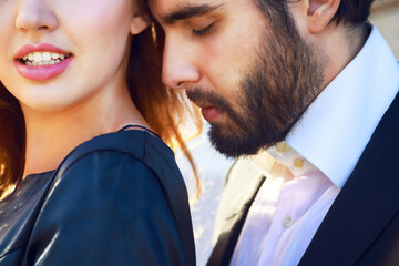 Fashion image of young blonde woman posing with her boyfriend