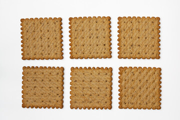 Pattern made of six spicy wholegrain rye crackers. Isolated. Top view, flatlay.