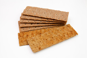 Stack of thin, crispy wholegrain rye breads isolated on white background.