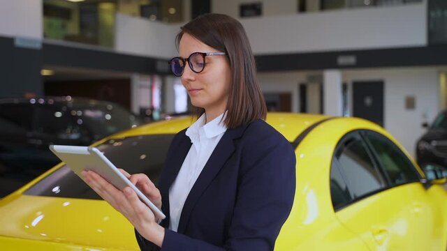 Sales manager in car dealership, saleswoman hold tablet and smile look at camera, portrait Spbas.