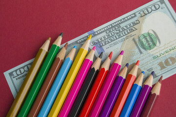 multicolored pencils on souvenir dollar bills