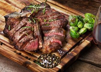 grilled and sliced steak on wooden table