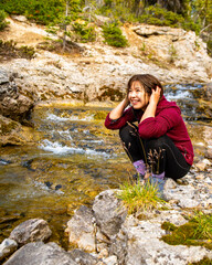 Obraz premium woman washing hair in the river