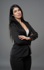 Latino businesswoman on gray