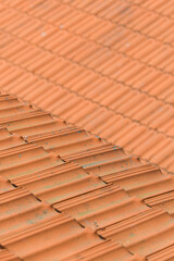 The texture of an orange tile roof building in plain sunlight