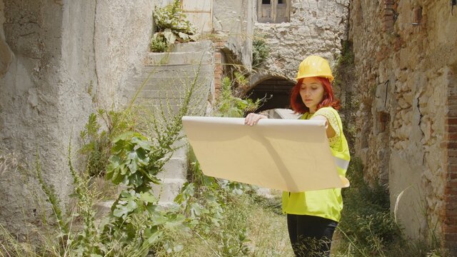 Giovane donna tecnico o ingegnere controlla la citt&agrave; distrutta dopo il terremoto