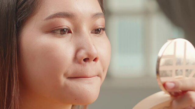 Closeup Of Asian Woman Face With Pink Matte Lipstick On Full Lips. Beauty Cosmetics And Makeup Concept

