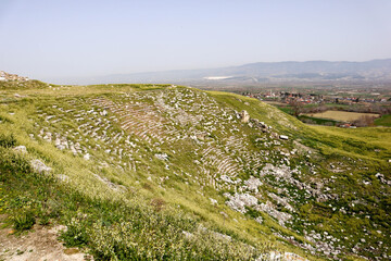 Fototapeta na wymiar ruins of ancient roman theatre overgrown with grass on Laodicea archaeological site, Turkey