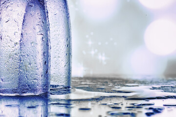 Background with tall glasses for sparkling wines. Champagne and spray in glass glasses. Celebratory drink with reflection.