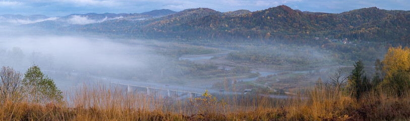 Morning fog on country foothills above Opir and Stryi rivers, and slopes of the Carpathian Mountains in far, Ukraine.