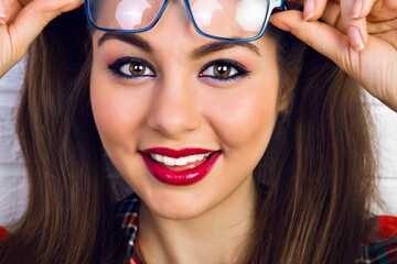 Fashion indoor portrait of young happy smiling pretty hipster teen girl