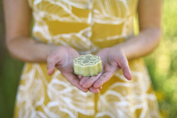 Woman shows handmade and organic soap in the forest