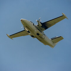 Twin-engine passenger aircraft with the landing gear retracted after takeoff gaining altitude