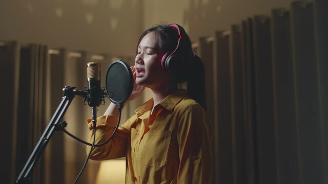Woman Singing In Recording Studio
