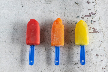 Three mini colored ice creams on white background