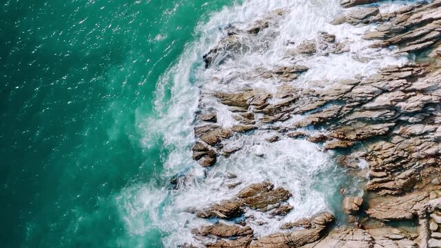 4K Aerial drone top down view bird eye view of sea blue waves break on rock and sand. Beautiful of sea water wave come to beach. Phuket Thailand tropical beach