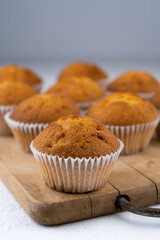 Biscuit muffins close-up. Sweet pastries. Party treat. Dessert on white table - homemade muffins. Portioned cupcakes. Simple muffin