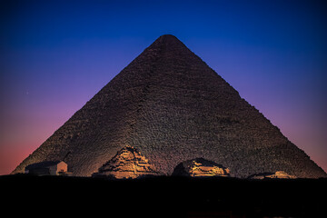 The Great Pyramid of Giza with Queen Pyramids at Night. 