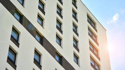 Modern apartment buildings on a sunny day with a blue sky. Facade of a modern apartment building. Glass surface with sunlight.