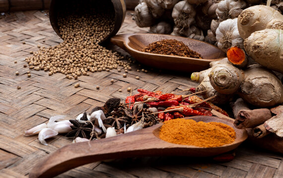 colourful spices in wooden tray. Asian popular cooking ingredients, dry hot healthy cook herbs. view form above and copy space background.
