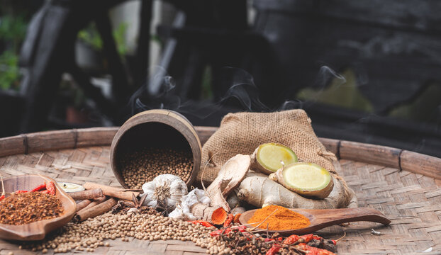 colourful spices in wooden tray. Asian popular cooking ingredients, dry hot healthy cook herbs. view form above and copy space background.