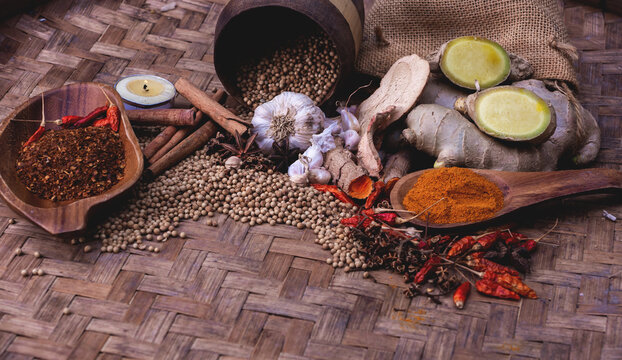 colourful spices in wooden tray. Asian popular cooking ingredients, dry hot healthy cook herbs. view form above and copy space background.