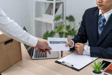 An executive or boss receives a resignation letter from an employee after the company announces a salary cut Resignation and vacancies and job changes