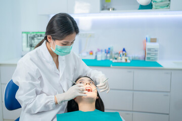 Dentist doctor check up, examine patient girl's teeth in dental clinic