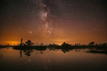 Swamp Bog Marsh Wetland Lake Nature Night Landscape. Night Starry Sky Milky Way Galaxy With Glowing Stars And Moon. Nature Night Sky Reflection In Water. Yelnya Swamp In Belarus