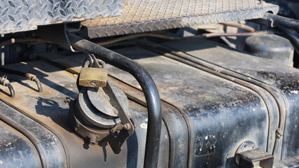 Lock the fuel tank. Tank cover with padlock to prevent truck diesel theft with copy space....