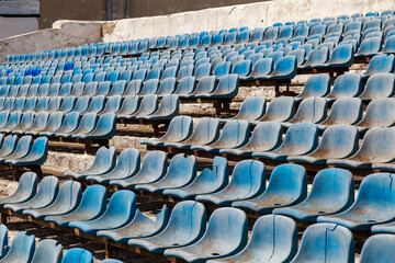 Destroyed stadium stands. Broken fan chairs. Selective focus