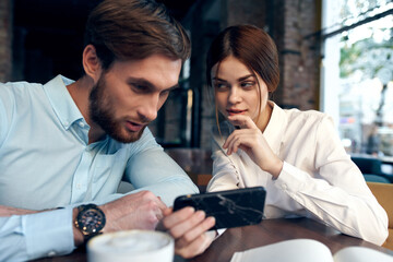 work colleagues sitting at work table communication phone technology emotions