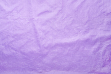 Delicate lilac silk texture. Slightly wrinkled fabric background