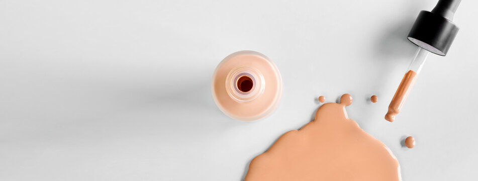 Banner with Mockup glass bottle of correction cosmetic product with pipette. Spilled Liquid foundation. Beauty branding concept