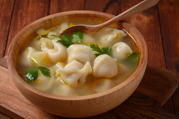 Soup with pelmeni (russian dumplings). Soup with meat dumplings, potatoes and other vegetables
