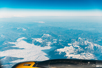 Aerial View From Airplane Window On Snowy Top Of Tatra Mountains In Summer Day. High Attitude.