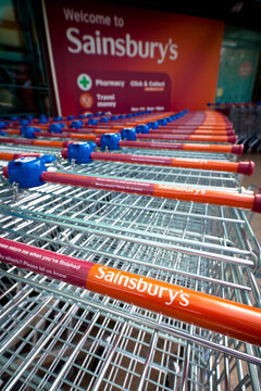 Bath, United Kingdom - April 24, 2011: A line of branded Sainsbury's shopping trolleys outside a Sainsbury's supermarket in Bath, England, UK.