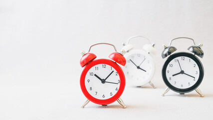 outstanding red analog alarm clock with blurred black and white on grunge gray background, leading performance concept