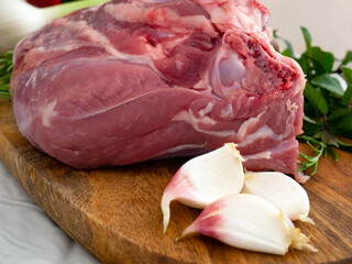 Fresh and raw meat. Leg of lamb on wood background