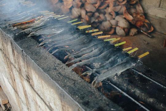 Cat fish barbecue grilled on hot charcoal stove in traditional way in Yogyakarta, Indonesia or normally called Mangut lele.