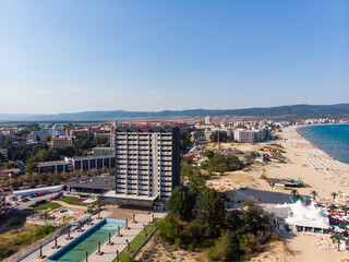 Fototapeta premium Aerial view of the sand beach, dune and closed hotels of Sunny Beach in Bulgaria. Summer holidays in Europe during quarantine. Aerial photography, drone view.