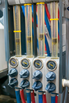 Flowmeter, rotameter - water flow regulator for cooling system of injection moulding machine at plant, factory - close up. Measuring and control equipment concept