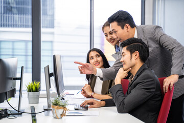 Businesspeople work on computer follow direction from leader in office