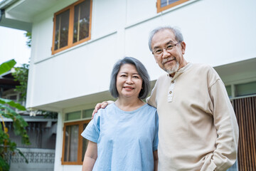 Portrait of Senior elderly grandparent couple at house look at camera 