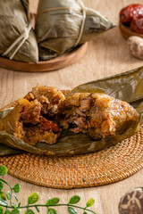 Zongzi or Bakcang is a traditional Chinese rice dish made of glutinous rice stuffed with different fillings and wrapped in bamboo leaves. They are cooked by steaming or boiling