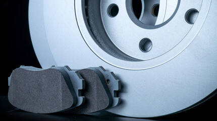 Car accessories. New metal car part. Auto motor mechanic spare or automotive piece isolated on black background. Technology of mechanical gear with space for text.